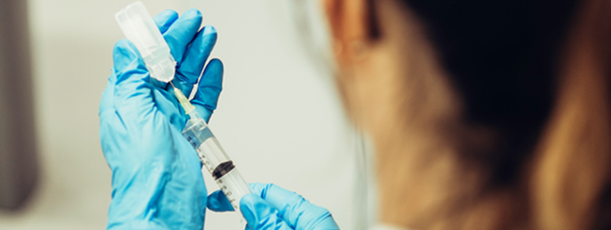 Doctor preparing a vaccine for injection