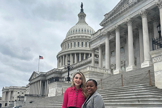 Erica Merlino and Thandi Ndlovu in front of Capital Building