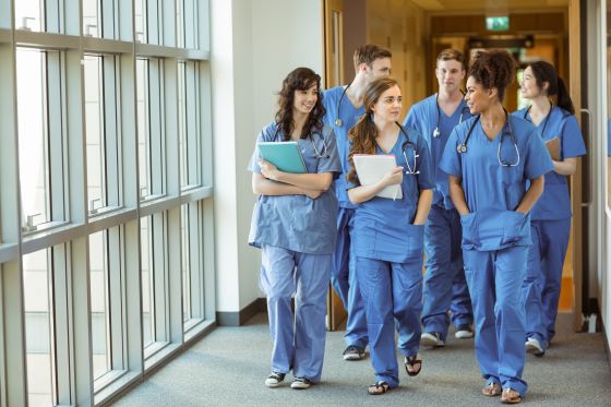 A group of doctors walking in a hallway.